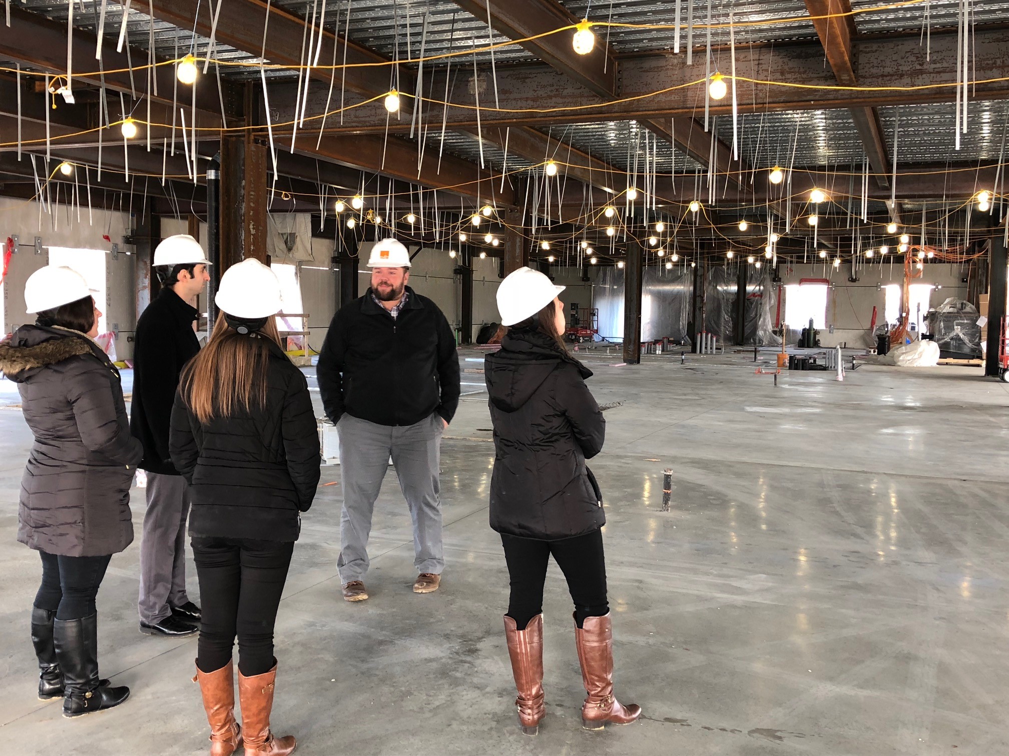 Architectural associates standing in medical facility building under construction