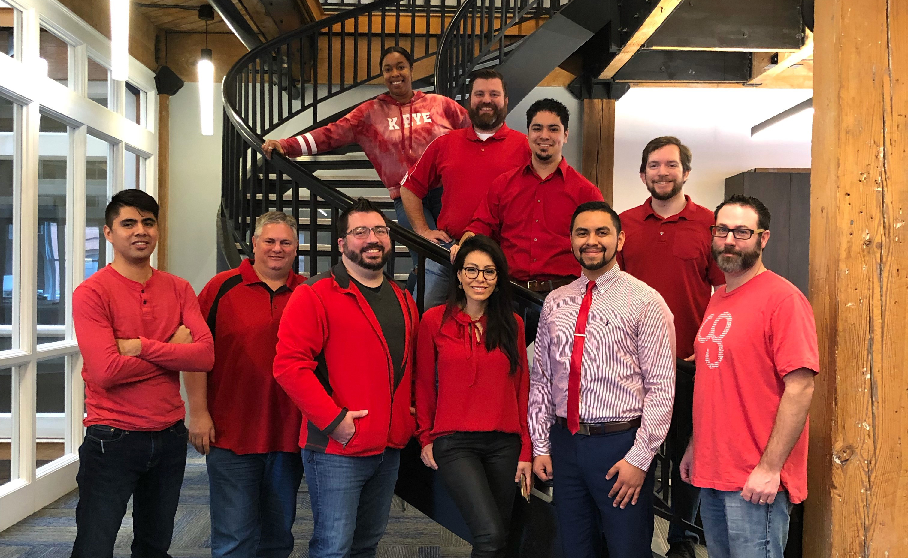 E4H Dallas team wearing red shirts standing in front of stairs