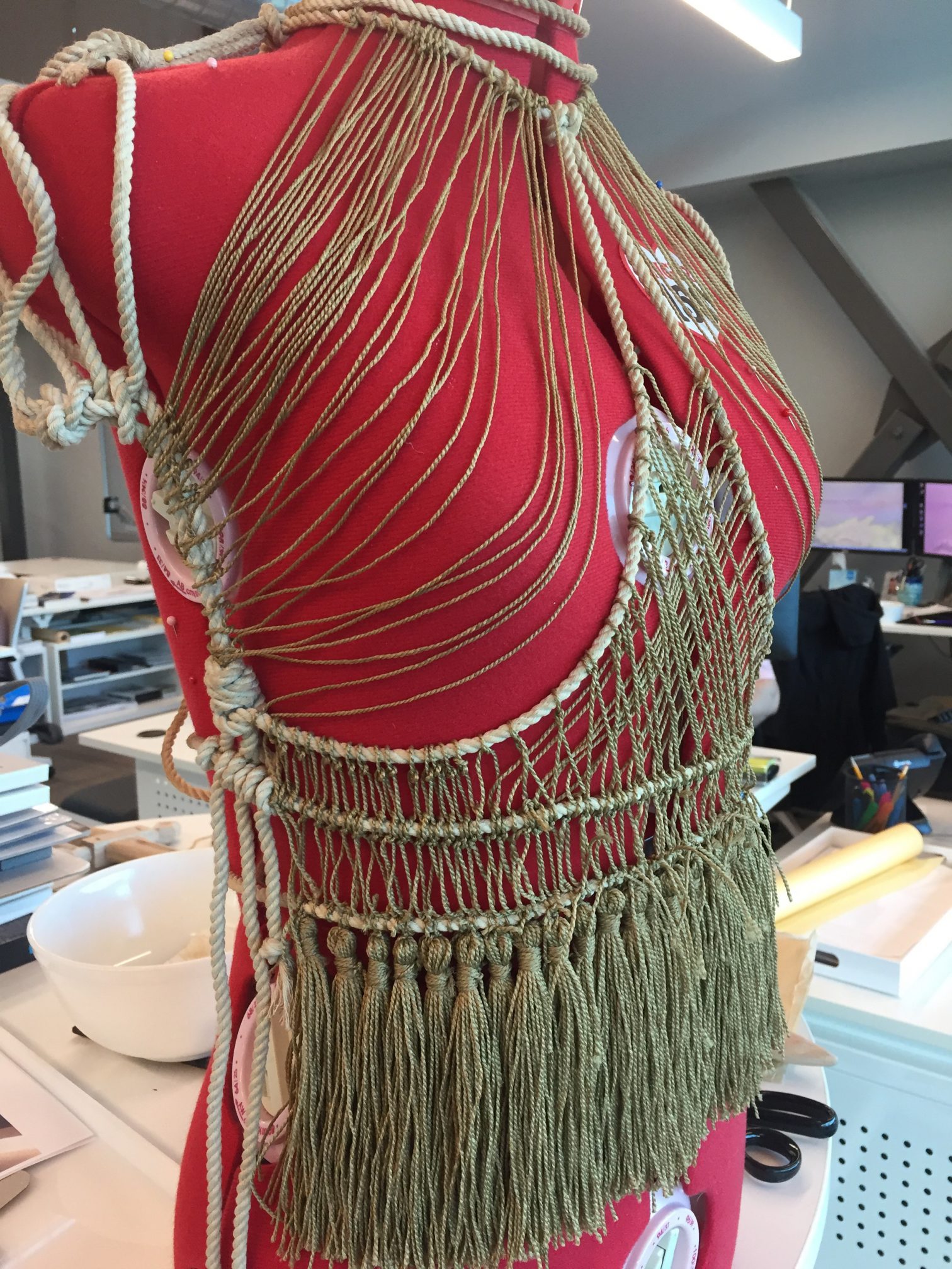 Shirt made of rope and string on red dress form
