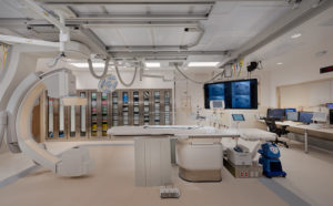 High tech, modern hospital lab room with CT scan, imaging equipment and monitors 