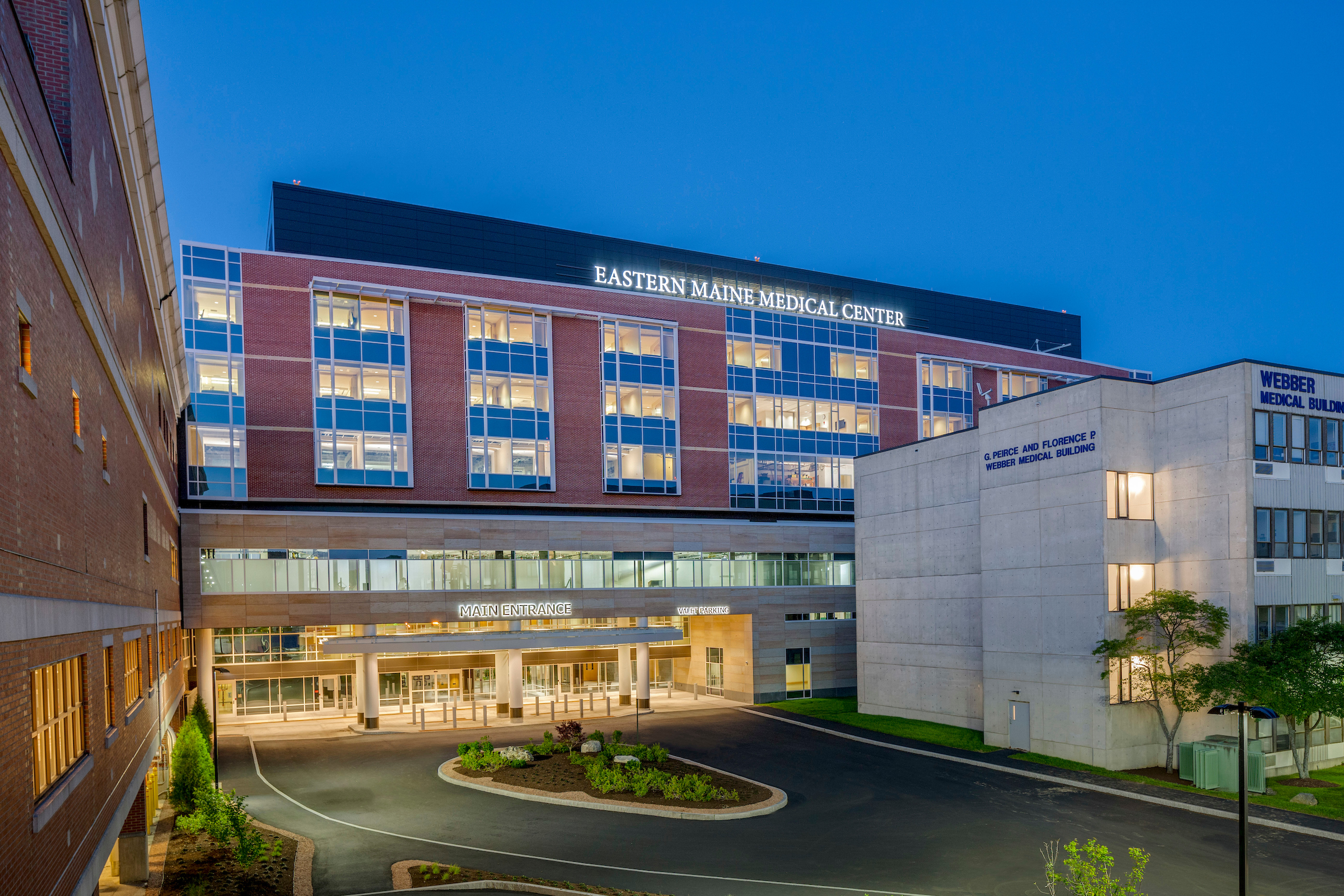 E4H designed building Eastern Maine Medical Center exterior with medical building to the right and trees surrounding it