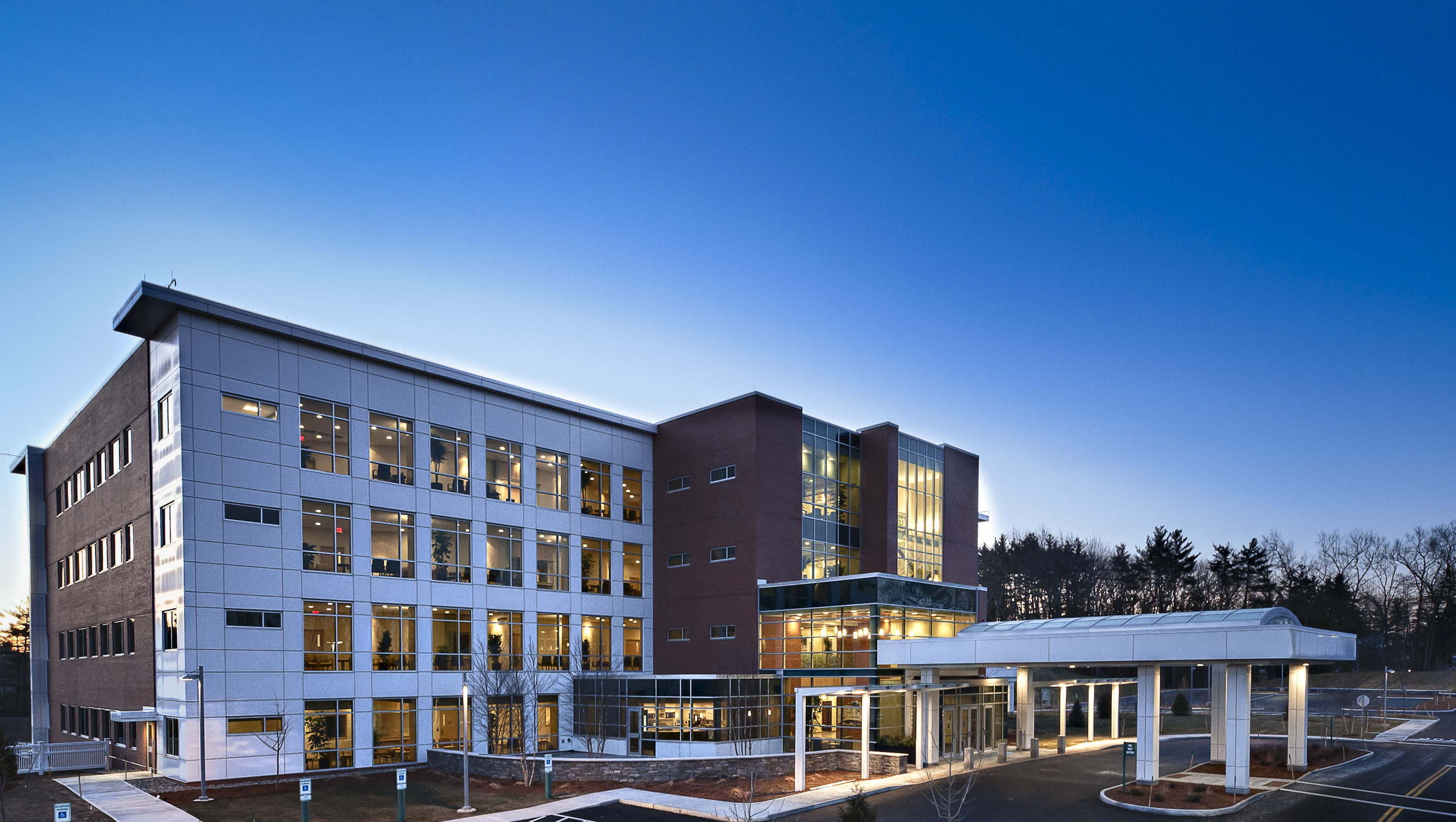 Exterior of Dartmouth-Hitchcock Nashua's main buildings showing entrance with blue sky background