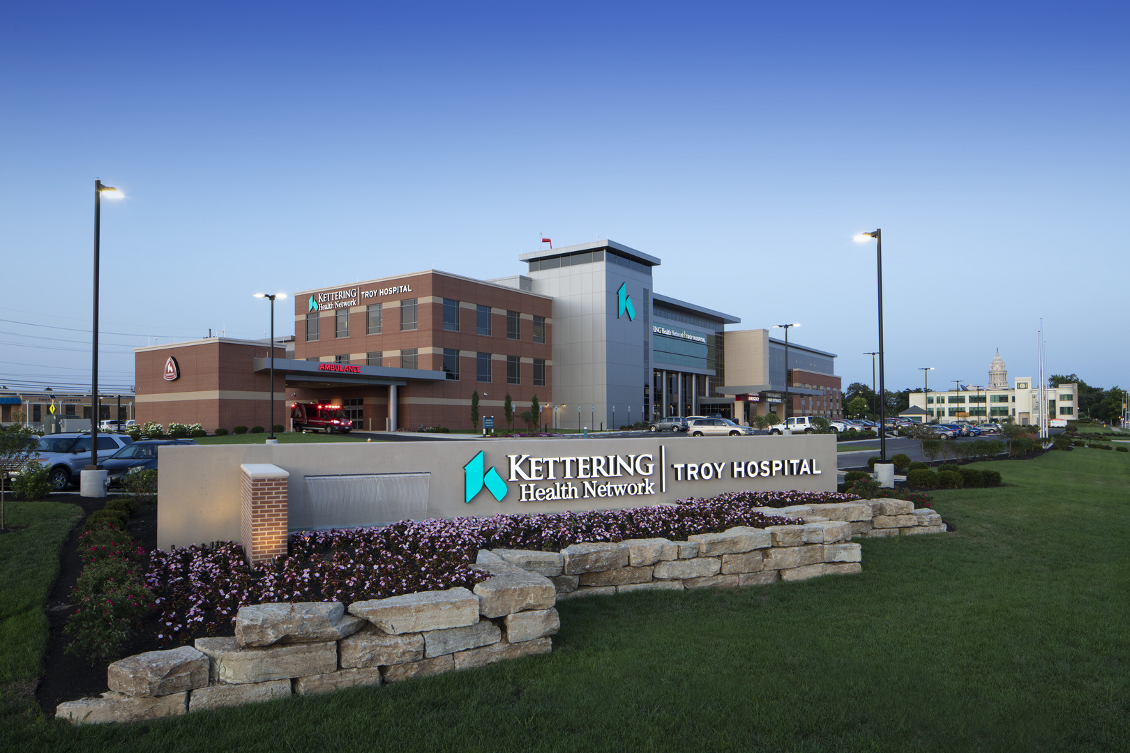 Kettering Health Network front view and sign with logo, surrounded by flowers