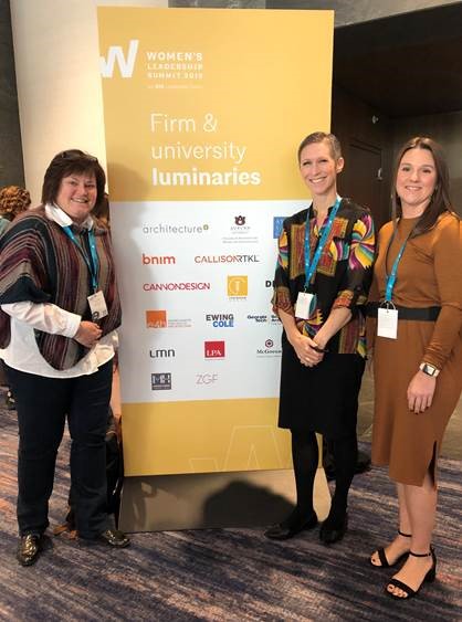 E4H Architecture Attends AIA Women's Leadership Summit - Three women standing in front of a sign at a work conference